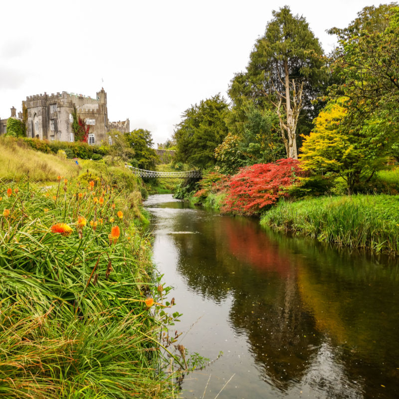 a river winds through the grounds of Birr Castle in Ireland