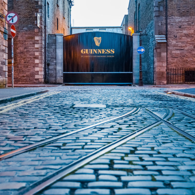 trolly tracks on a cobblestone street lead the way to St. James Gate at the Guinness Storehouse