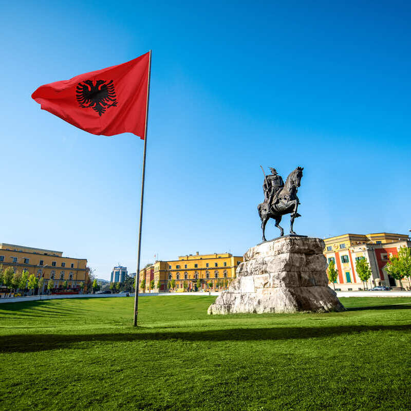 Albanian Flag Flying On A Flagpole In Skanderberg Square, Tirana, Albania, Balkan Peninsula, South Eastern Europe