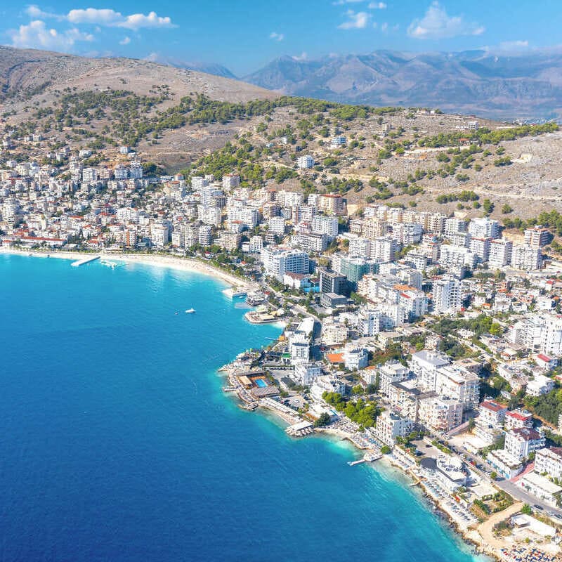 Aerial View Of Saranda, A City On The Albanian Riviera Facing The Turquoise Colored Adriatic Mediterranean Sea, Albania, Balkan Peninsula, South Eastern Europe