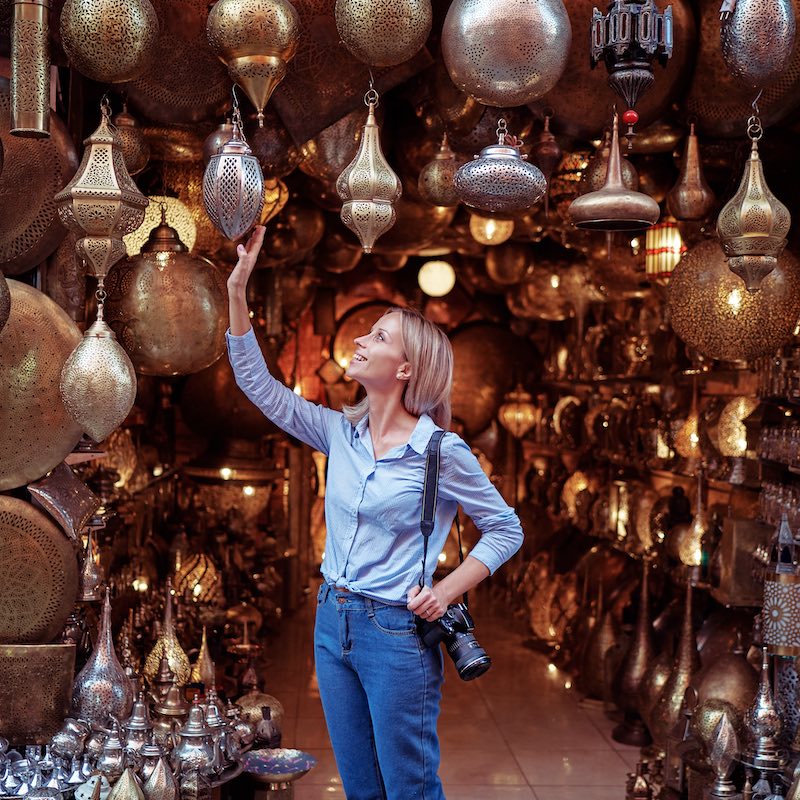 Woman admiring lamps in Morocco