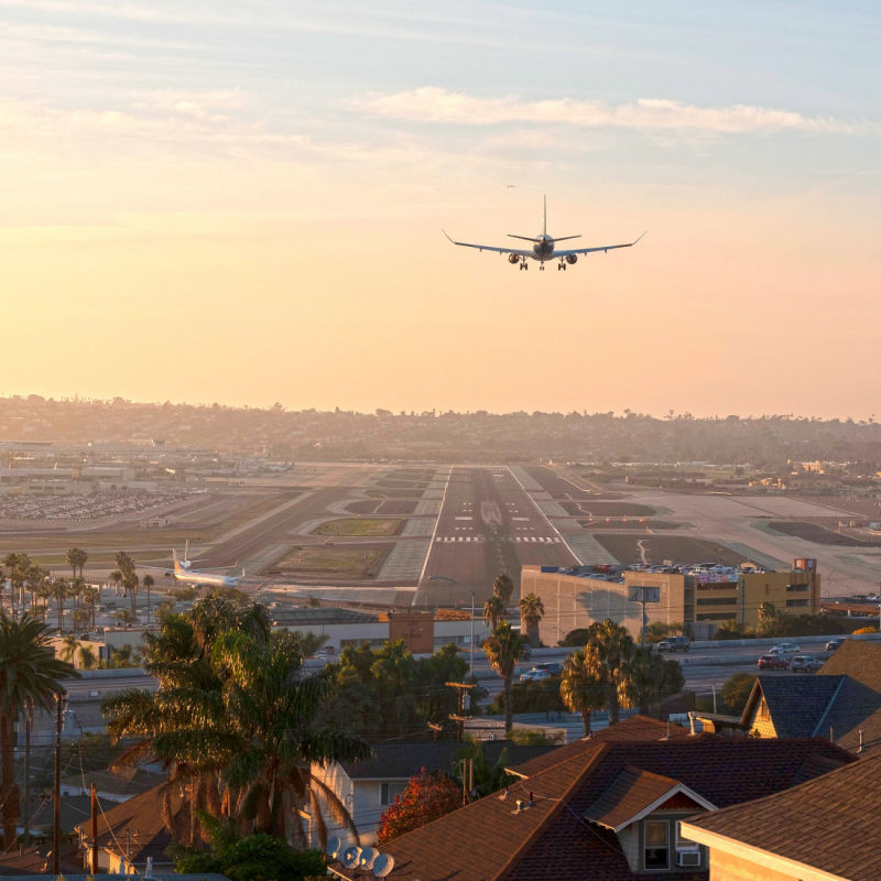 An Alaska Airlines plane flies over the San Diego Airport