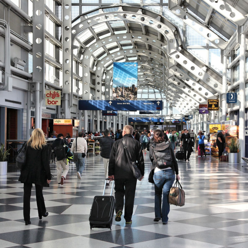Travelers walk to gates at Chicago O'Hare International Airport in USA.