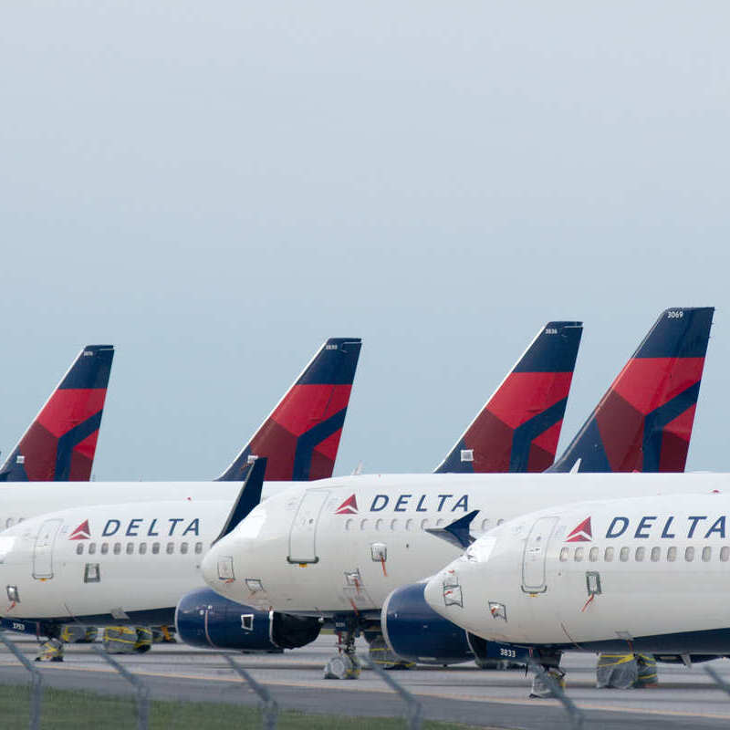 Delta Airlines Aircraft Parked In A Row At An Unspecified Airport