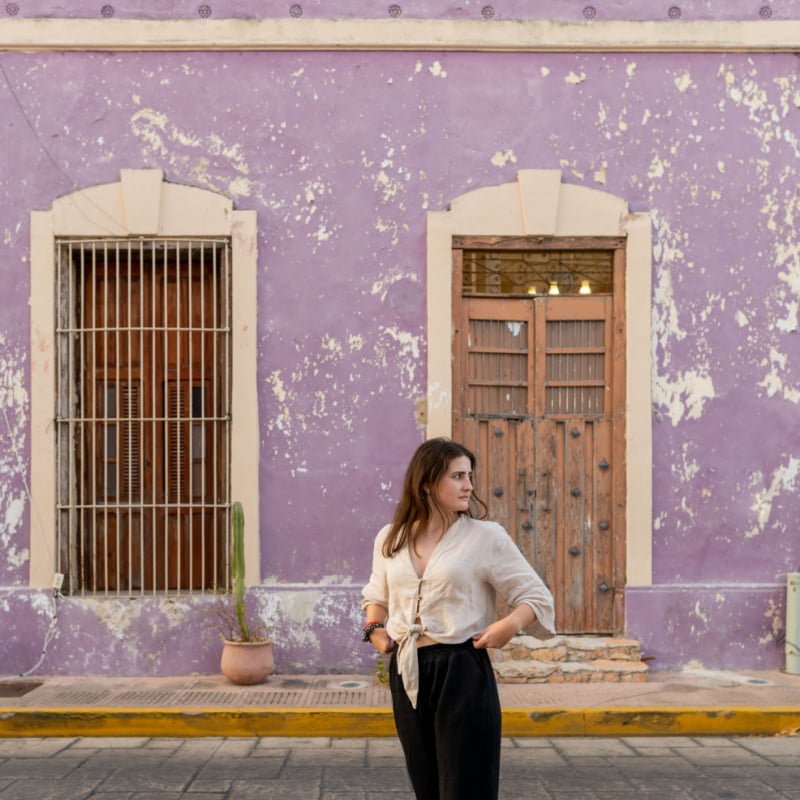 Young woman visiting the city of Merida in Yucatan, Mexico. Tourist destination with colorful houses and streets, typical of the country.