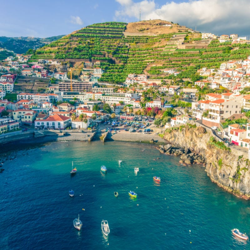 Aerial drone view of Camara de Lobos village panorama near to Funchal, Madeira. Small fisherman village with many small boats in a bay.jpg