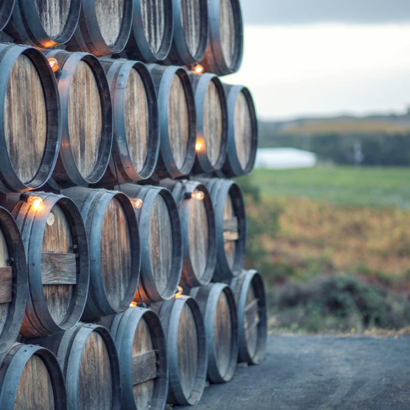 a stack of wooden barrels in napa valley wine country in california