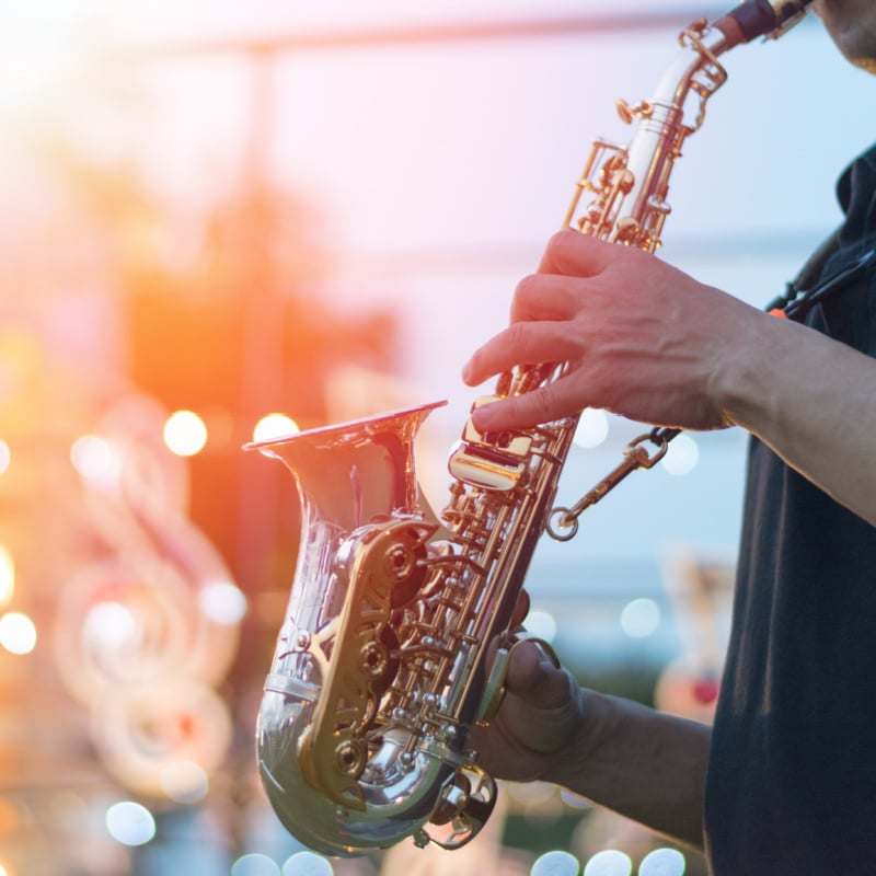 close up of a saxaphone being played at a jazz festival on stage
