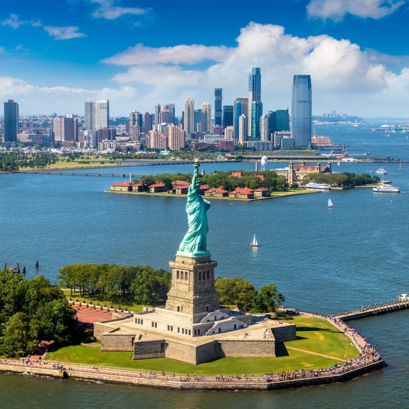 Statue of Liberty and Jersey City and Manhattan cityscape in New York City