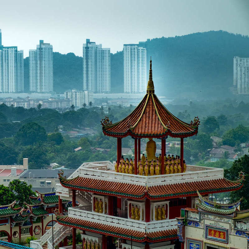 Kok Lek Si Temple With A Cluster Of Skyscrapers In The Background, Penang, Malaysia, Southeast Asia