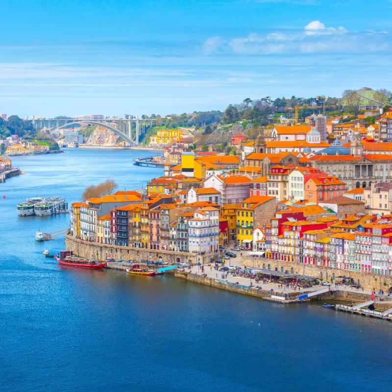 Porto, Portugal old town ribeira aerial promenade view with colorful houses, Douro river and boats