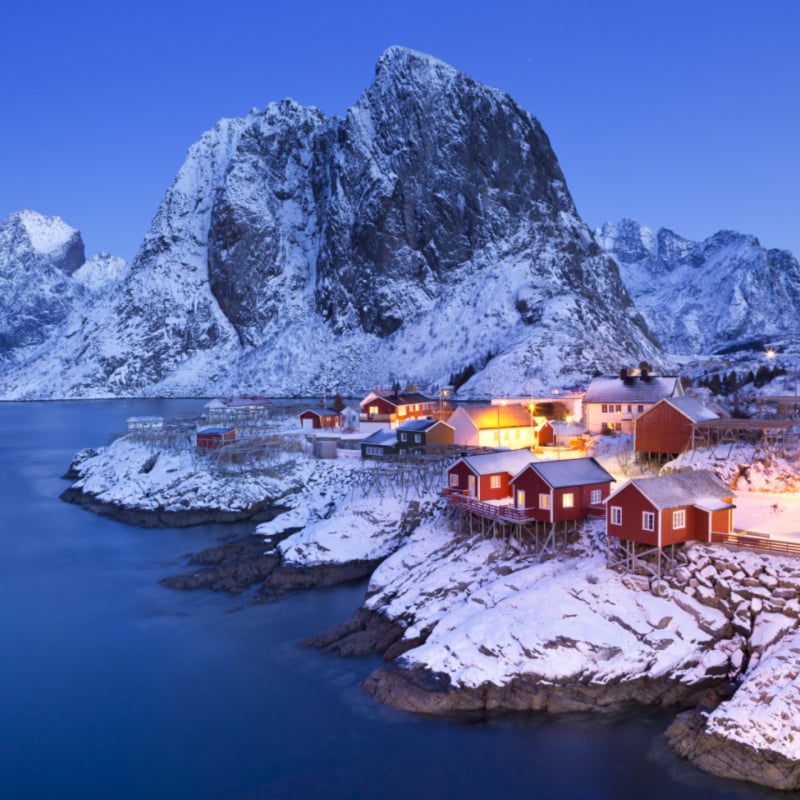 Traditional Norwegian fisherman's cabins, rorbuer, on the island of Hamnoy, Reine on the Lofoten in northern Norway. Photographed at dawn in winter.